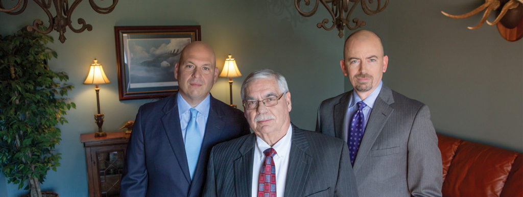 Lexington Injury Attorneys inside office looking at camera