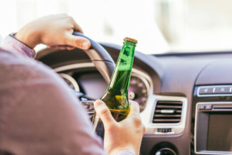 The driver drinking alcohol while driving