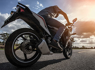 man riding motorcycle on the road