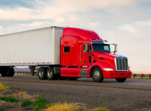 18 wheeler red truck on the road.