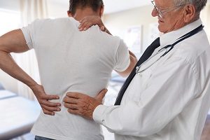 Doctor seeing possible back injury cause by an accident