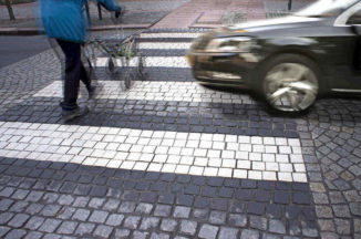 man about to get hit at a pedestrian crossroad