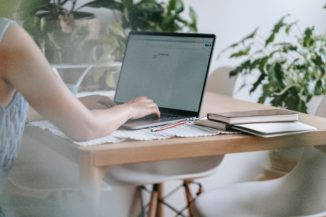 working woman typing on her laptop