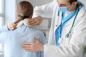 the doctor is examining the woman's neck and back