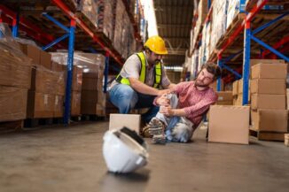 Amazon warehouse injury lawyer helping injured worker on warehouse floor in Kentucky