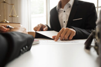 Lawyer explaining something to their client before signing some documents